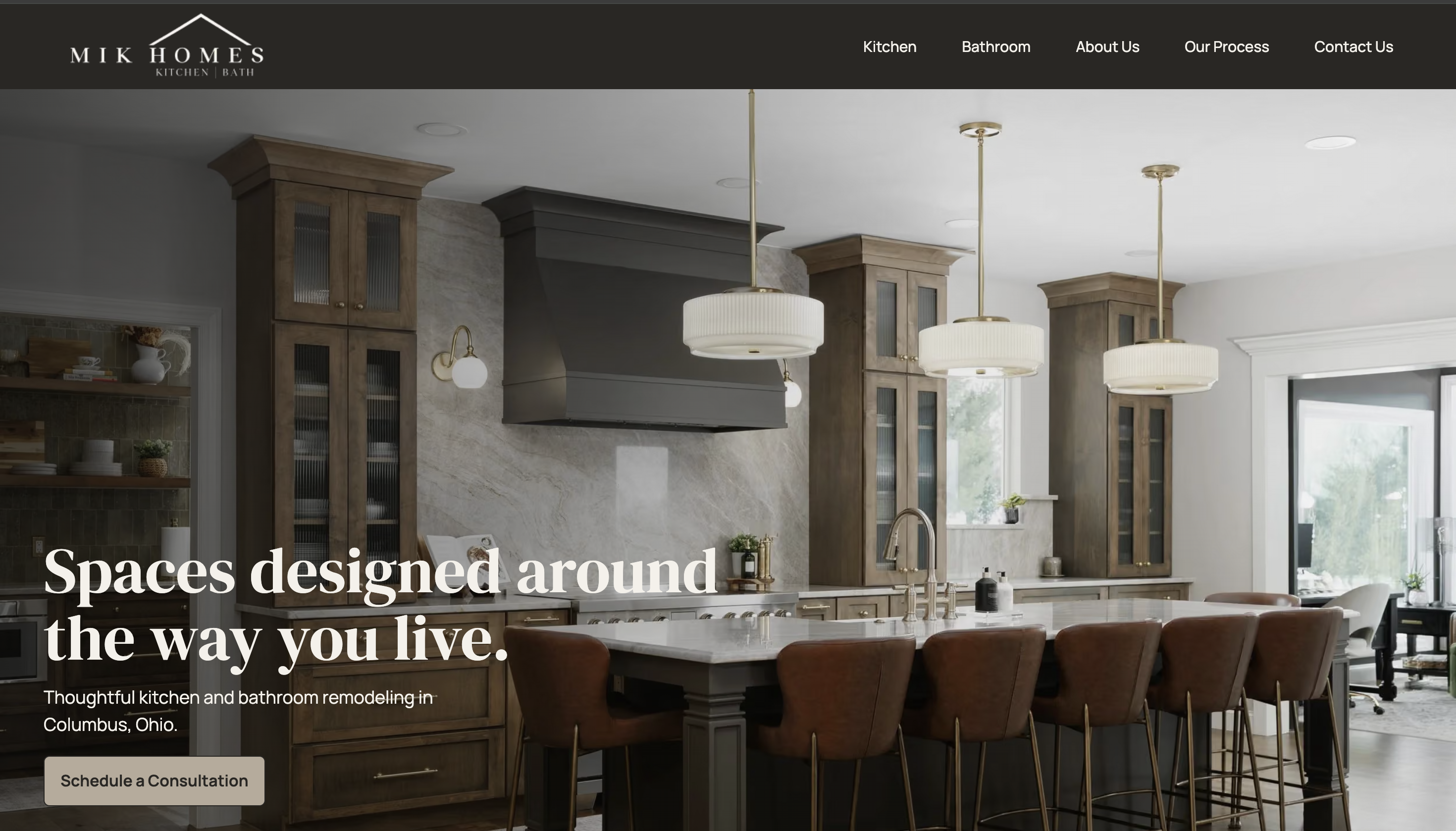 MIK Homes redesigned homepage displayed on a laptop